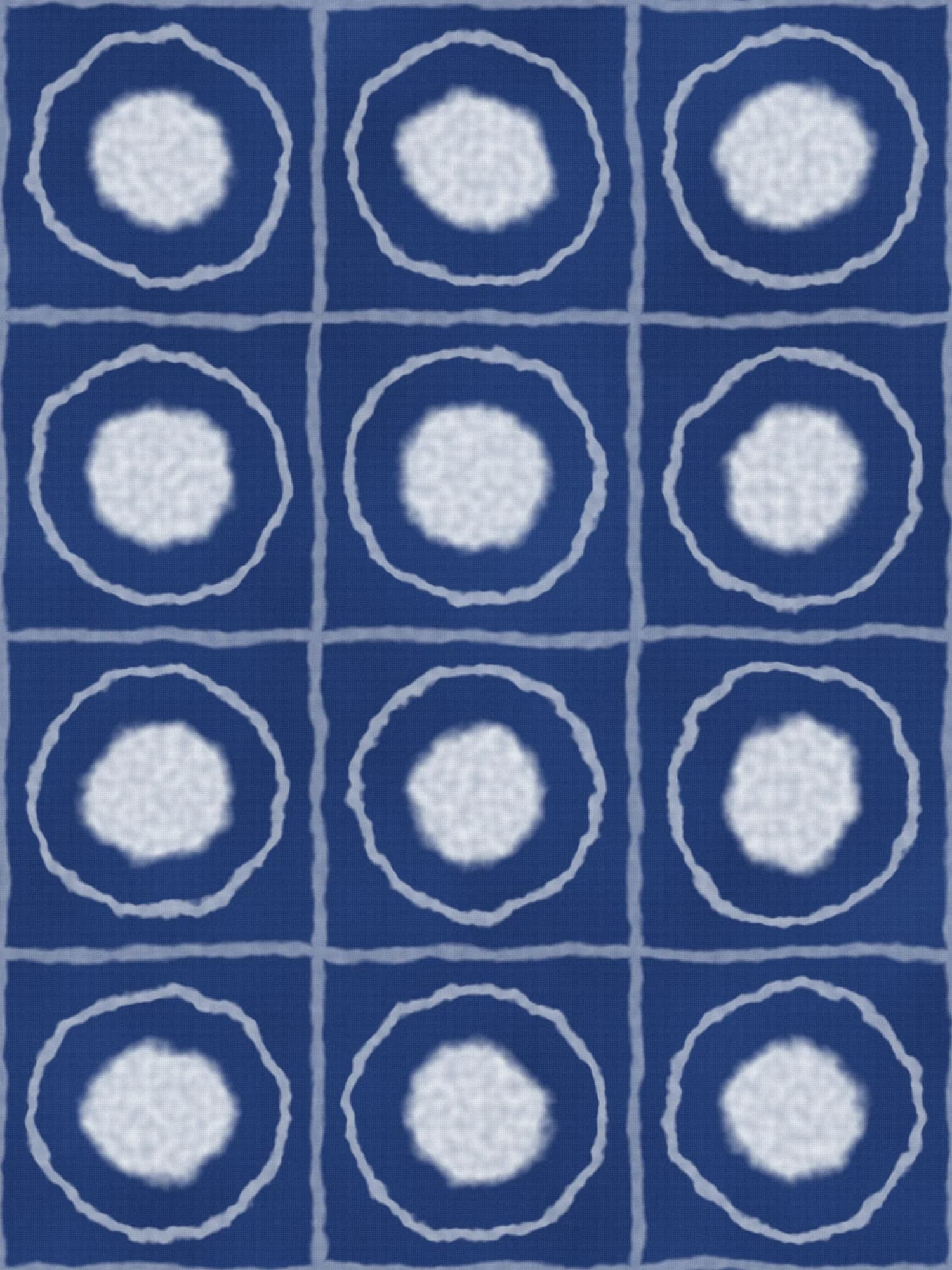A deep indigo dyed cloth with a grid of pale resist circles and soft bleeding lines
